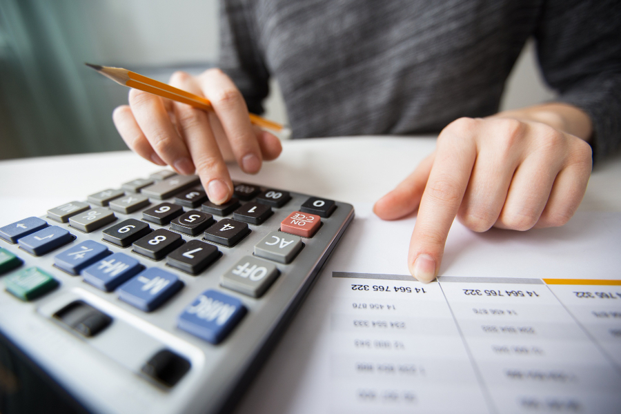 Center closeup accountant hands counting calculator