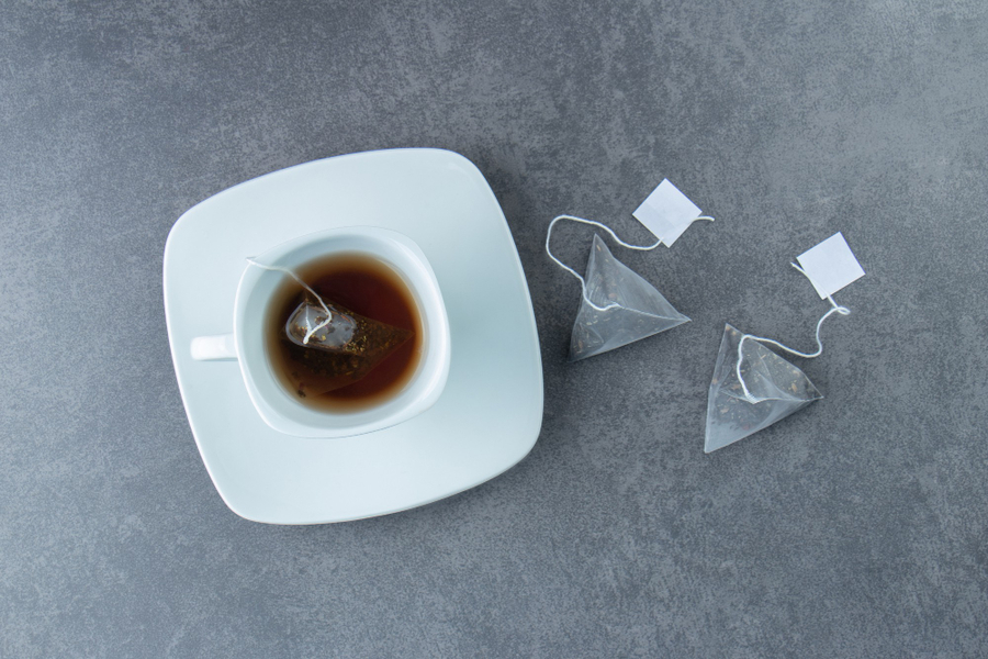 Center white cup hot tea with teabags